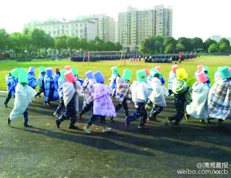 Weird punishment: College freshmen bathe in sunshine in quilts during military training