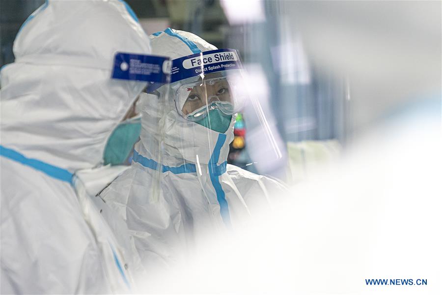 Medical workers take care of patients in Wuhan
