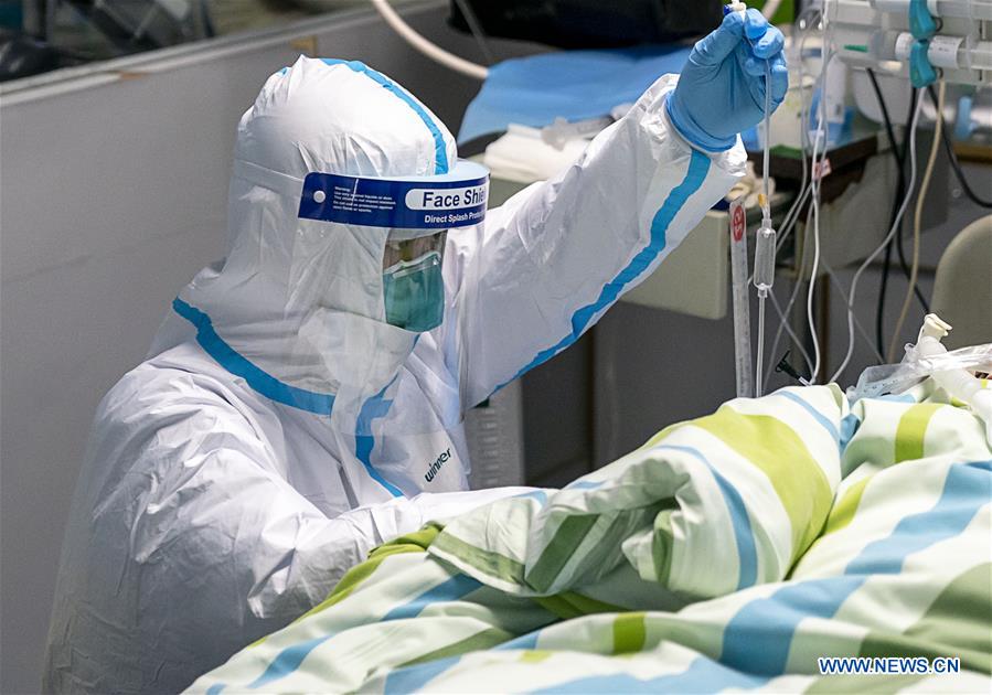 Medical workers take care of patients in Wuhan