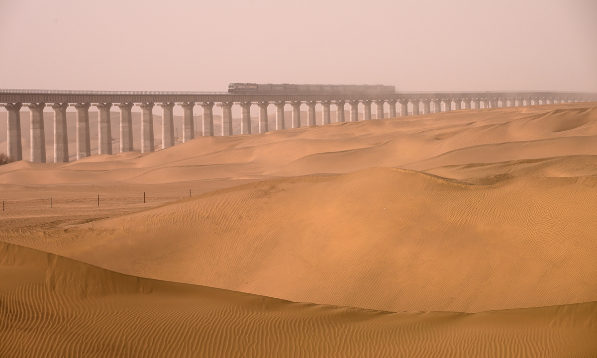 A train moves along the 825-kilometer Hotan-Ruoqiang railway in Northwest China's Xinjiang Uygur Autonomous Region in a test run. Photo: Courtesy of China State Railway Group