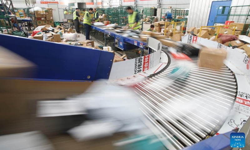 Staff members sort packages at a logistic center of Daoxian branch of China Post in Daoxian County, central China's Hunan Province, Nov. 11, 2024. Manufacturers, e-commerce platforms and logistics companies across the country are busy coping with consumer's demand during China's annual 